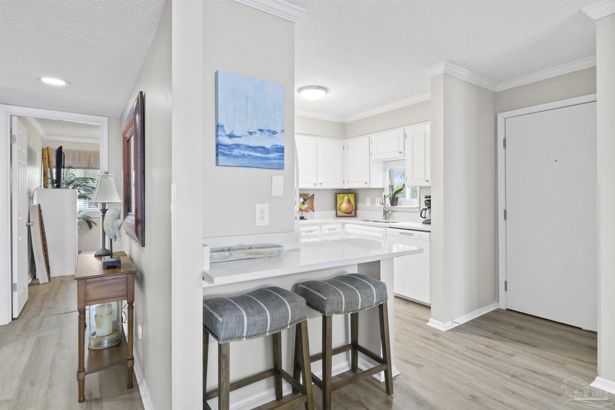 16470 Perdido Key Drive, Unit C24 Perdido Key, FL 32507 - Photo 17 of 48 a kitchen with stainless steel appliances granite countertop a refrigerator and a stove top oven