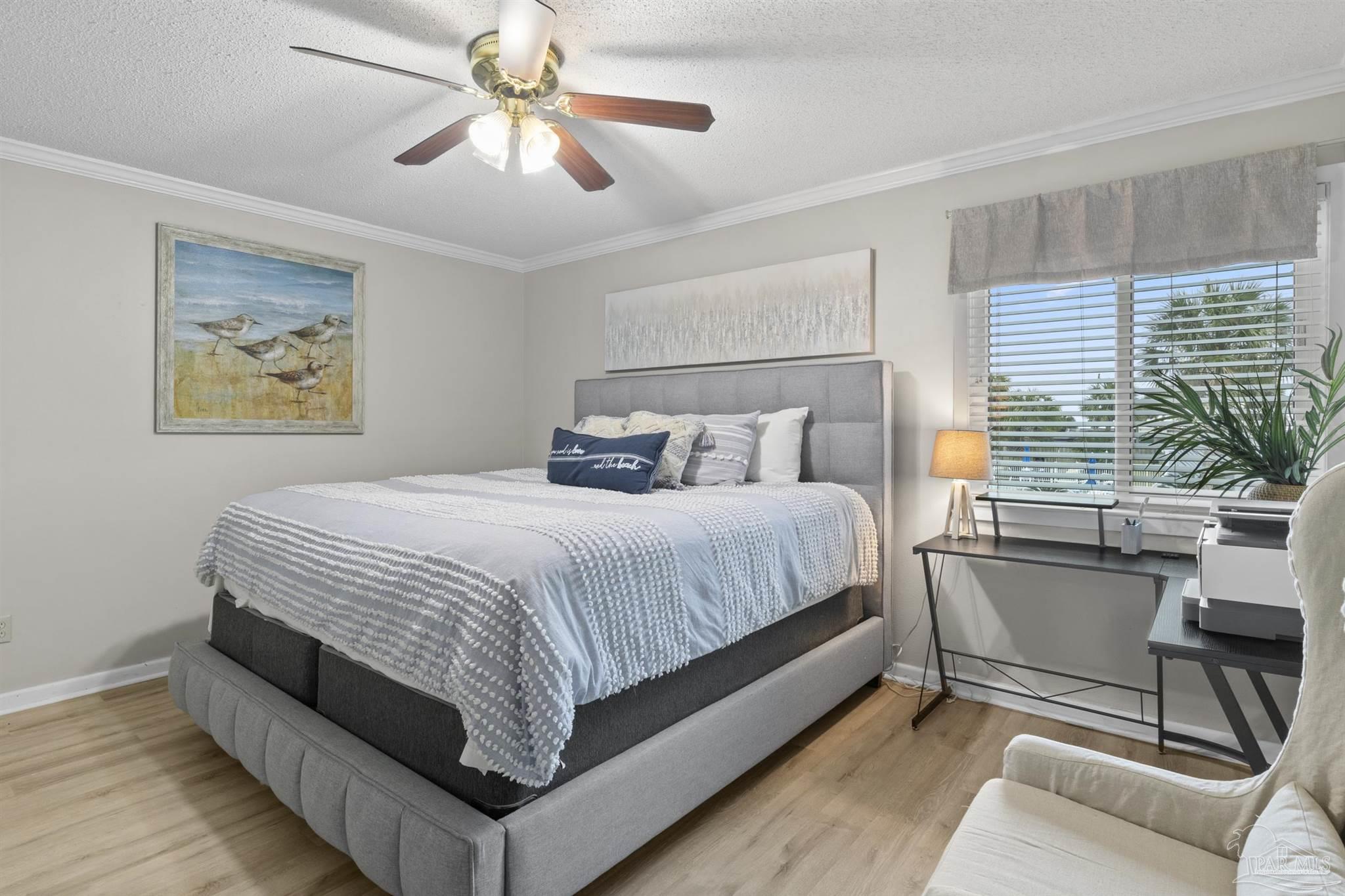 16470 Perdido Key Drive, Unit C24 Perdido Key, FL 32507 - Photo 22 of 48 a bedroom with a bed and a chandelier