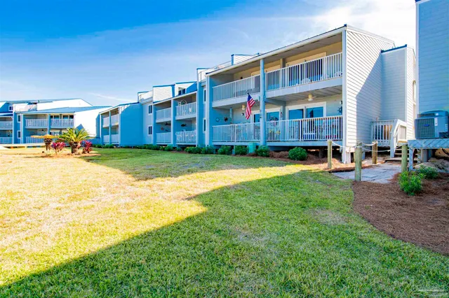 a view of a big building with a big yard and large trees