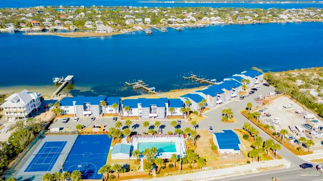 a view of an ocean with a floor to ceiling window and potted plants