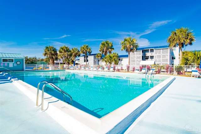 a view of a swimming pool with an outdoor seating