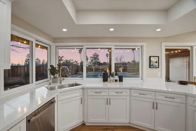 a view of a house with swimming pool and sitting area