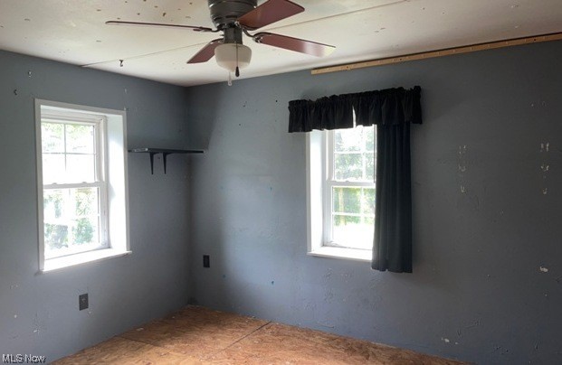 1220 Arner Road Chester, WV 26034 - Photo 17 of 24 Empty room with a healthy amount of sunlight and ceiling fan