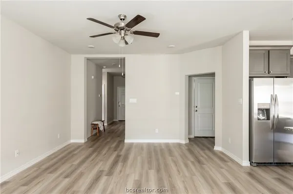 a view of empty room with wooden floor