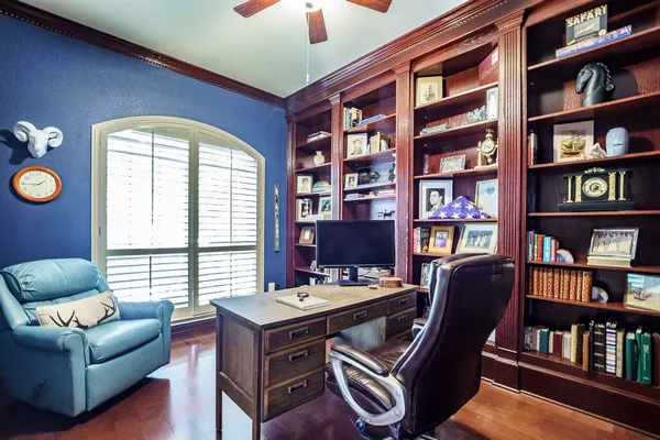 a living room with furniture kitchen view and a chandelier