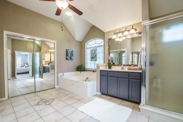 a large bathroom with a glass door shower and sink
