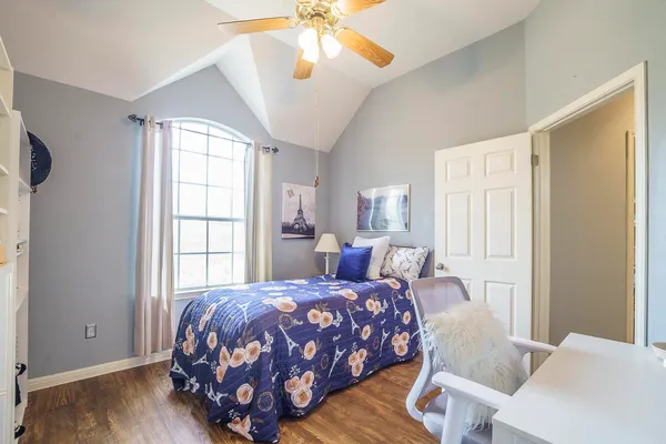 a bedroom with a bed and a chandelier