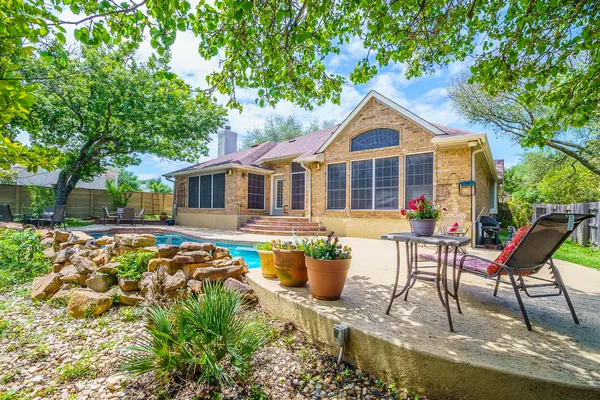 a front view of house with yard seating and patio