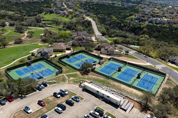 an aerial view of a pool and a yard