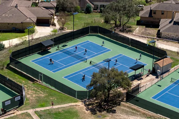 a view of a tennis ground with a large pool