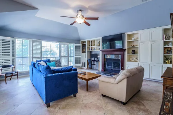 a living room with fireplace furniture and a window