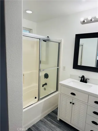 a bathroom with a toilet a sink a mirror a vanity and window