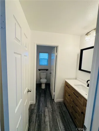 a bathroom with a toilet sink and mirror