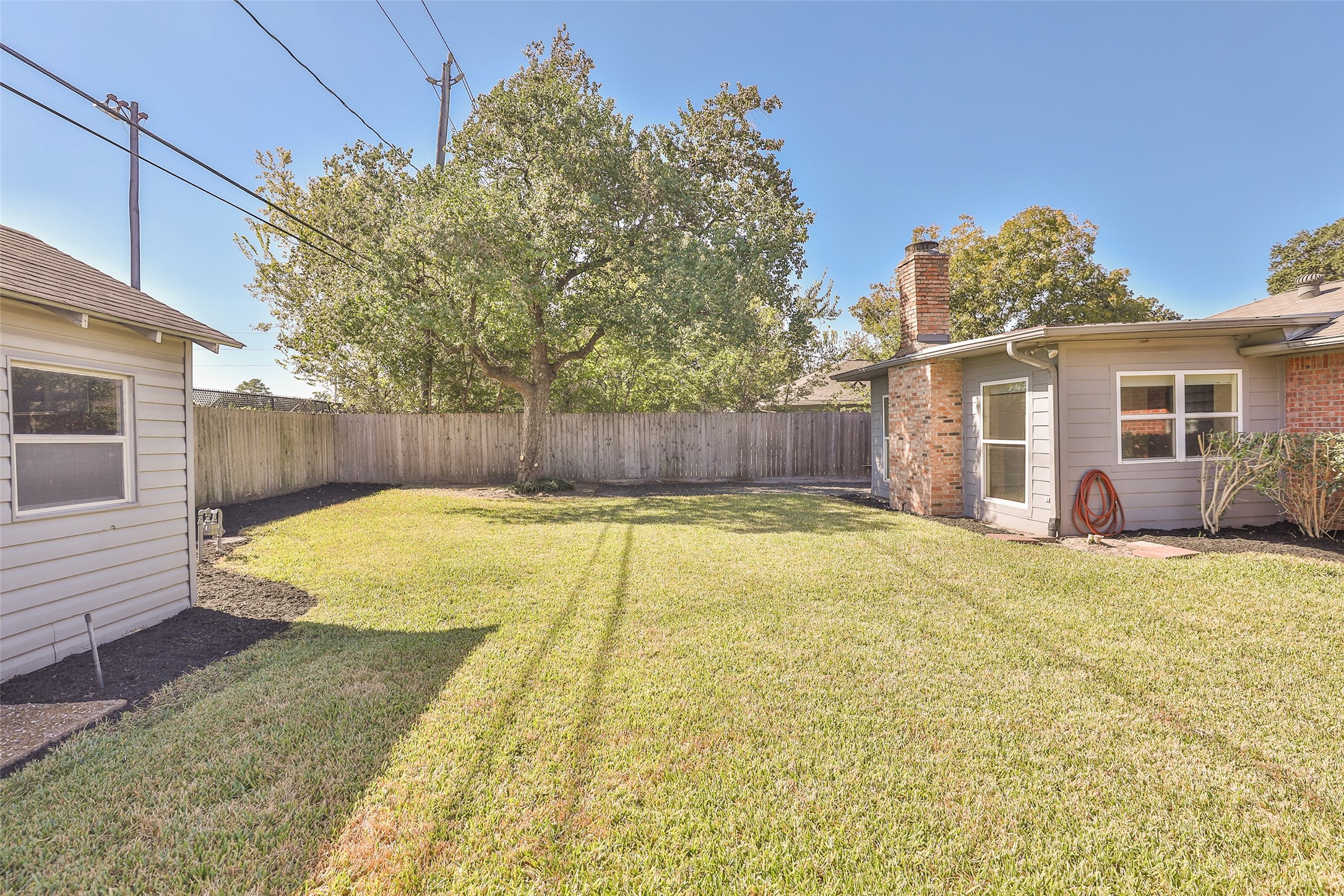 4613 Libbey Drive Houston, TX 77092 - Photo 25 of 26 a bathroom with a tub and trees in the background