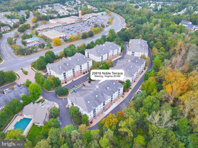 an aerial view of residential house with outdoor space and a street view
