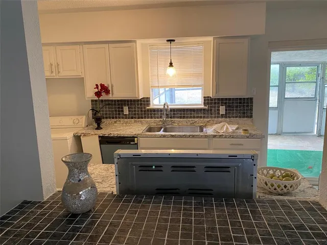 a kitchen with a stove a sink and a microwave