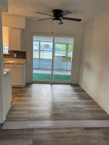 a view of a room with wooden floor and a window