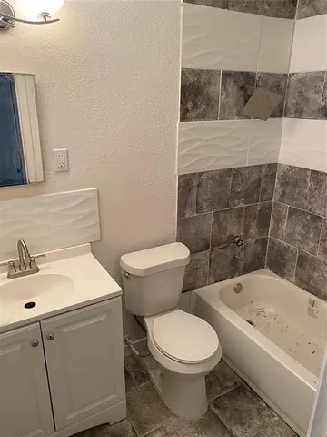 a bathroom with a sink a toilet and bathtub