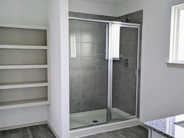 a bathroom with a glass shower door