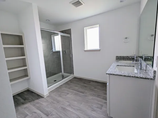 a bathroom with a granite countertop sink and a mirror