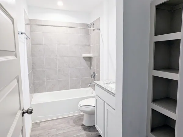 a bathroom with a toilet and a shower