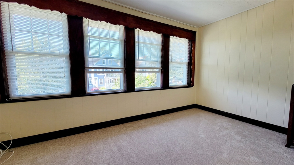 149 Powder House Boulevard, Unit 149 Somerville, MA 02144 - Photo 11 of 11 a view of an empty room with a window