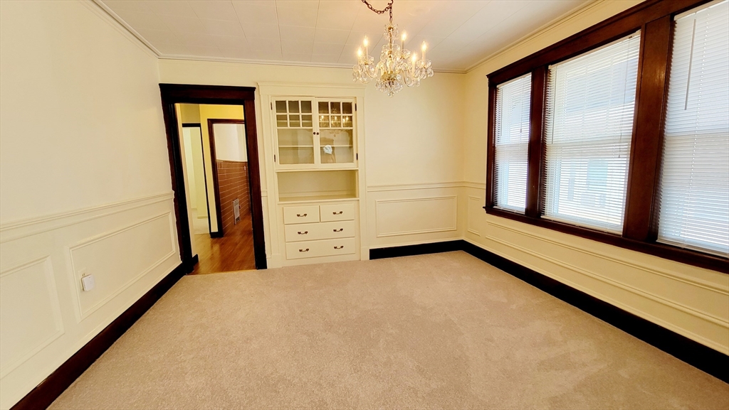 149 Powder House Boulevard, Unit 149 Somerville, MA 02144 - Photo 8 of 11 a view of an empty room with a window
