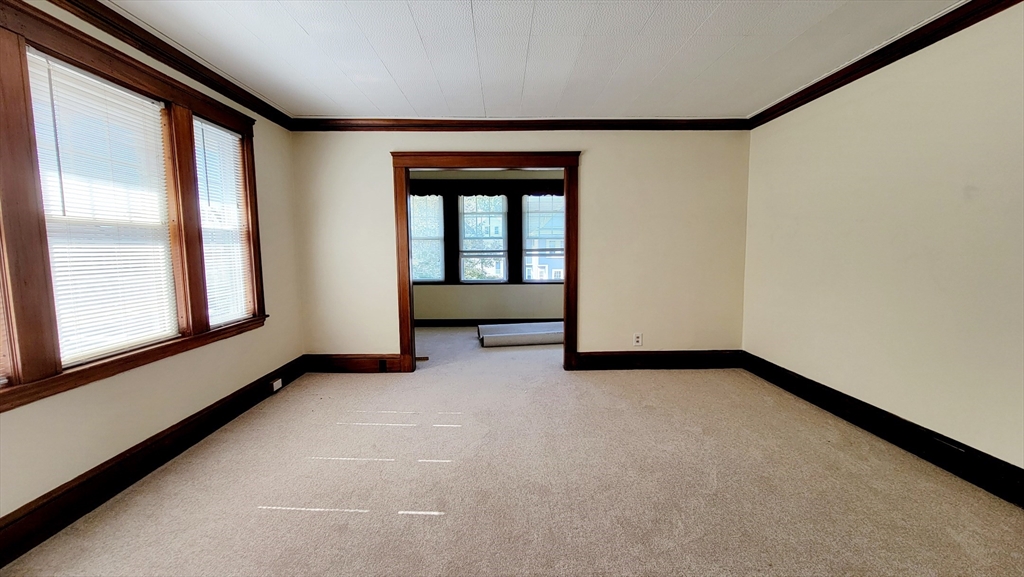 149 Powder House Boulevard, Unit 149 Somerville, MA 02144 - Photo 9 of 11 a view of an empty room with a window