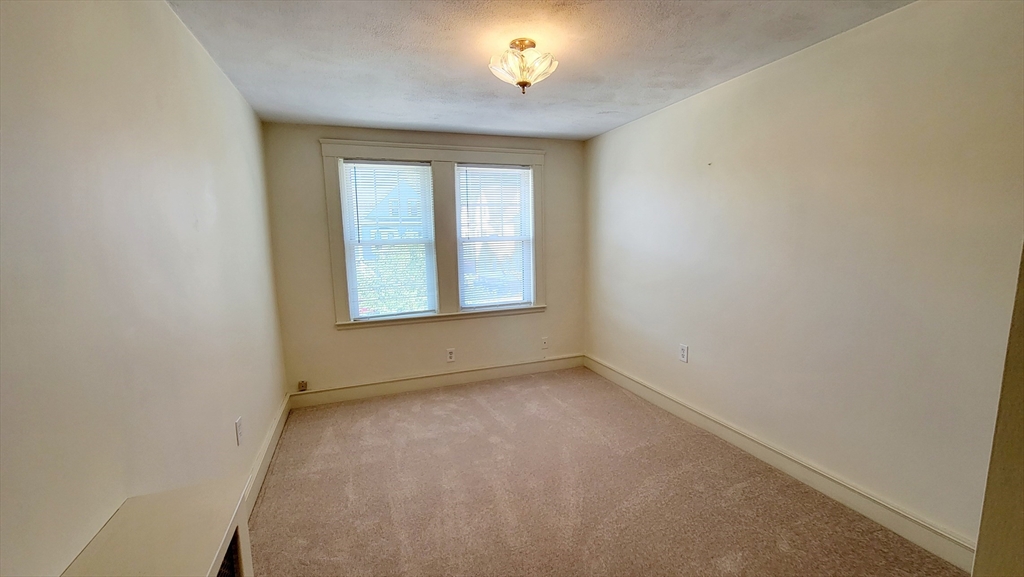 149 Powder House Boulevard, Unit 149 Somerville, MA 02144 - Photo 10 of 11 an empty room with a window