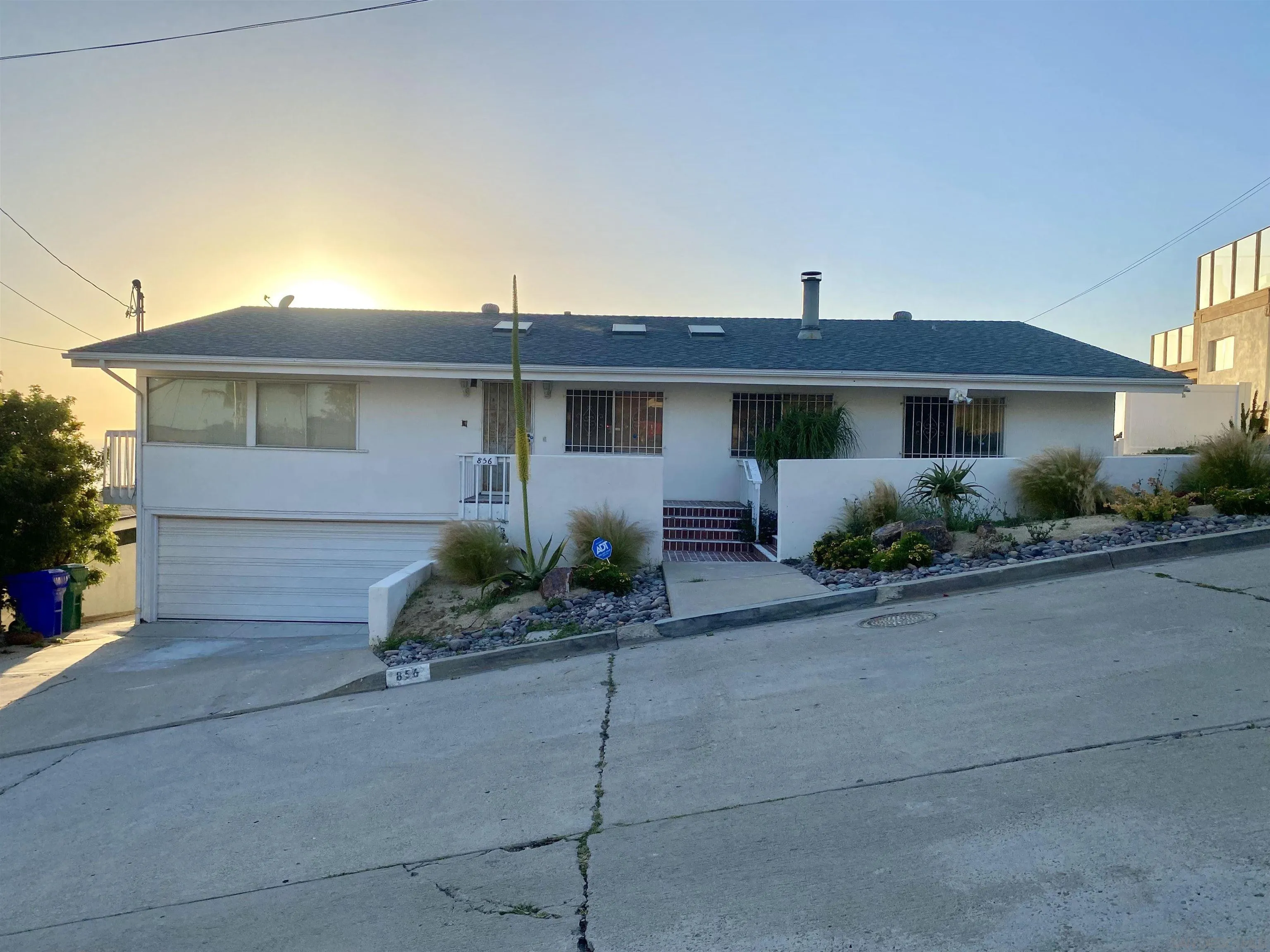 856 La Jolla Rancho Road La Jolla, CA 92037 - Photo 7 of 18 a front view of a house with a yard