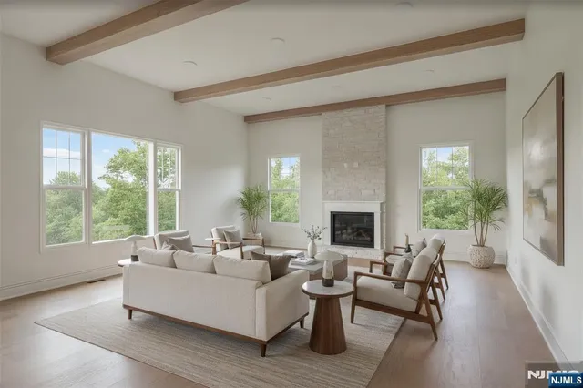 a living room with furniture fireplace and a large window
