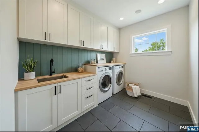 a utility room with sink dryer and washer