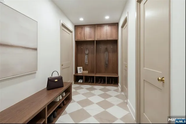 a view of a hallway with wooden cabinets