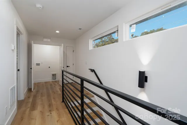 a view of a hallway with wooden floor