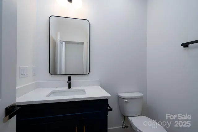 a bathroom with a sink a toilet and mirror