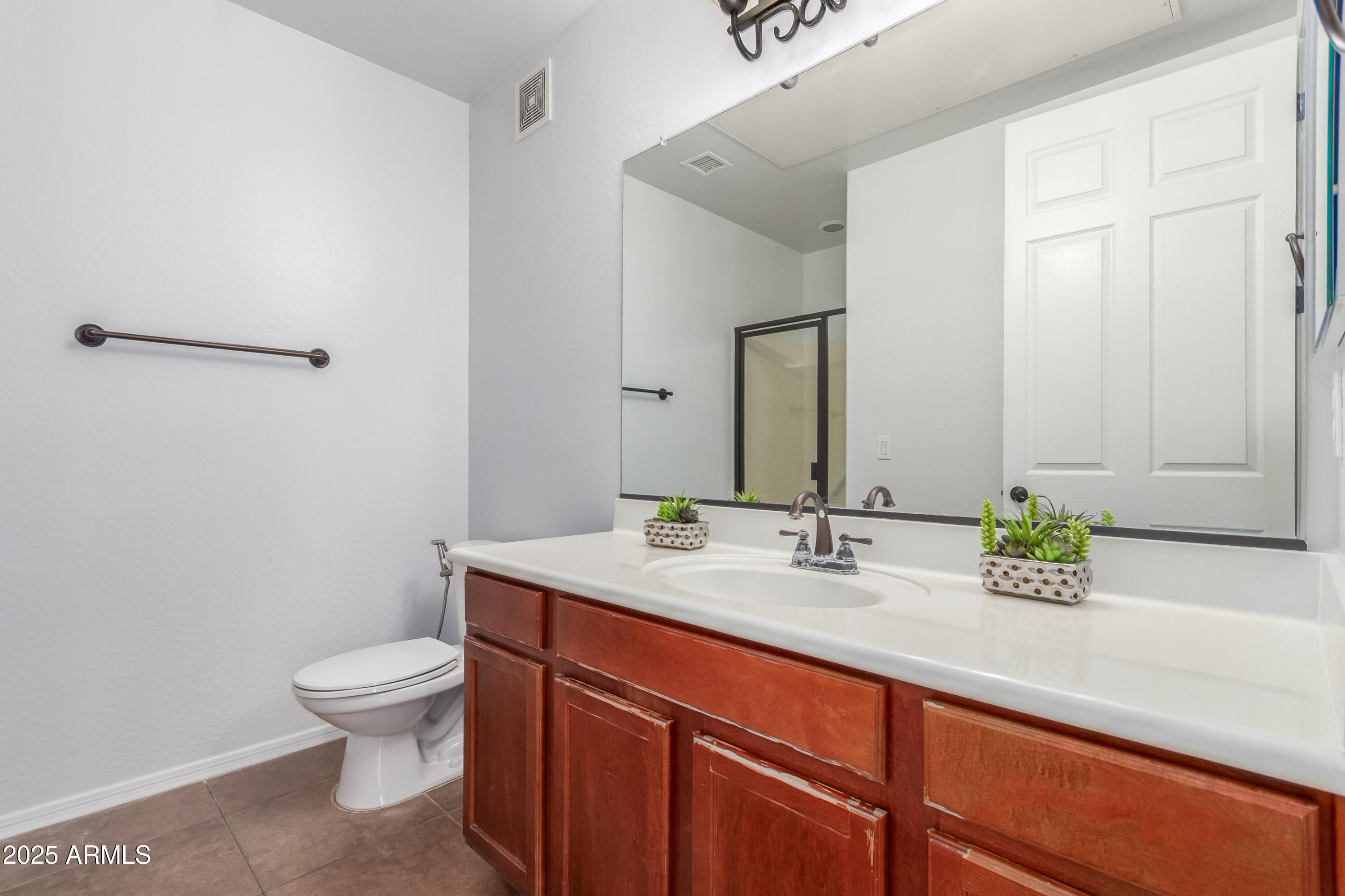 3330 South Gilbert Road, Unit 2018 Chandler, AZ 85286 - Photo 14 of 24 a bathroom with a sink a toilet and mirror