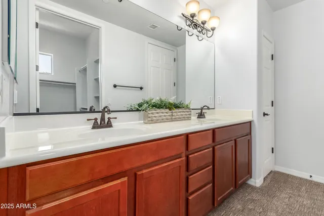 a bathroom with a double vanity sink and a mirror