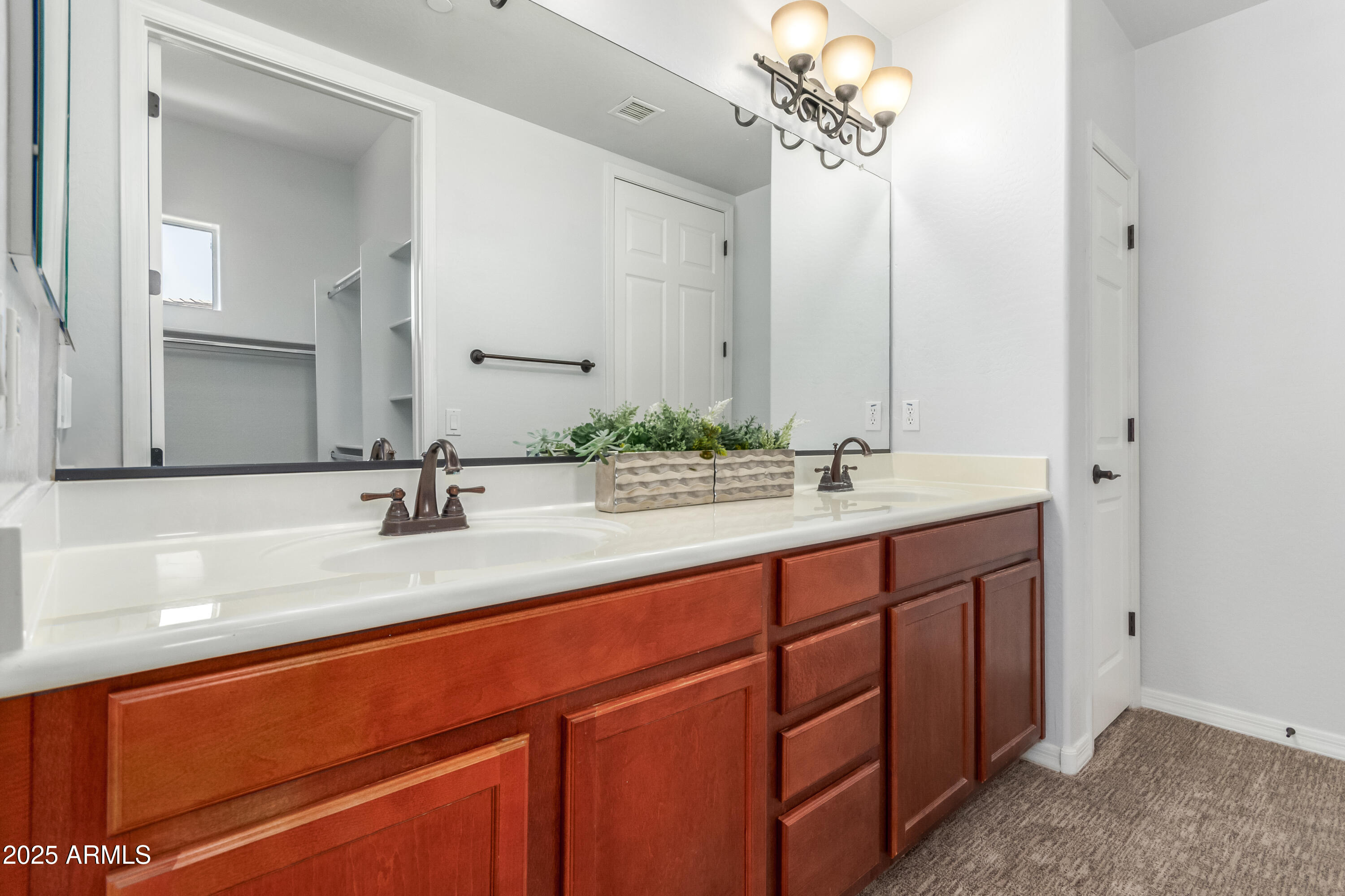 3330 South Gilbert Road, Unit 2018 Chandler, AZ 85286 - Photo 17 of 24 a bathroom with a double vanity sink and a mirror