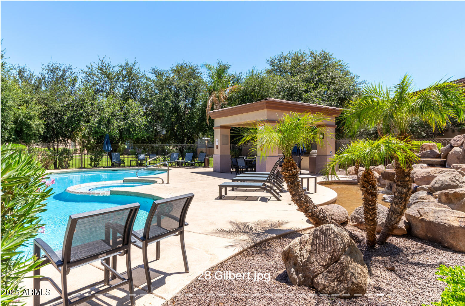 3330 South Gilbert Road, Unit 2018 Chandler, AZ 85286 - Photo 24 of 24 a view of a patio with chairs and table with potted plants