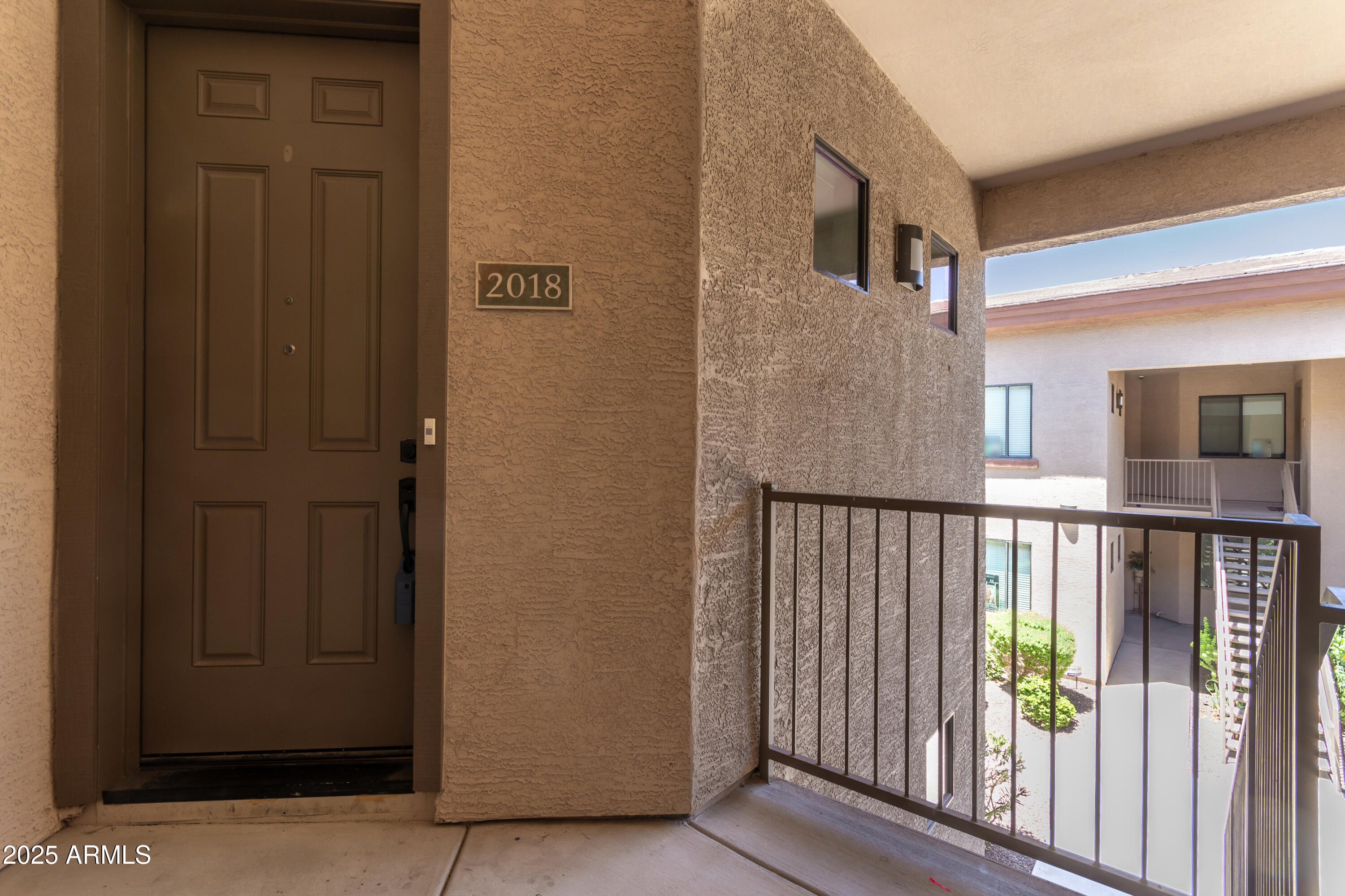 3330 South Gilbert Road, Unit 2018 Chandler, AZ 85286 - Photo 3 of 24 a view of a porch with wooden floor