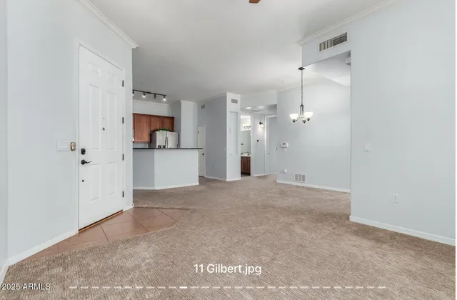 a view of a kitchen with a sink and a refrigerator