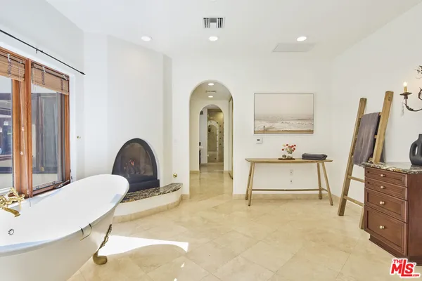 a living room with furniture bathtub and a flat screen tv