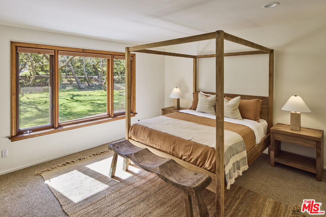 6138 Ramirez Canyon Road Malibu, CA 90265 - Photo 14 of 31 a bedroom with a bed and a window