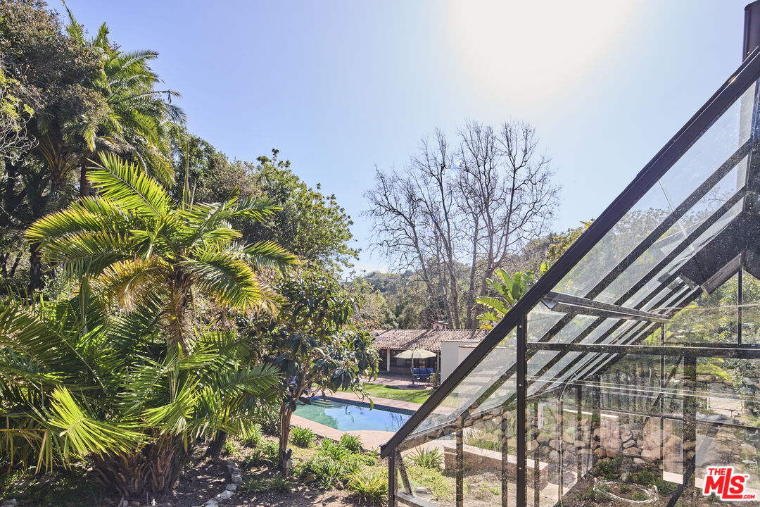 6138 Ramirez Canyon Road Malibu, CA 90265 - Photo 20 of 31 a backyard of a house with lots of green space