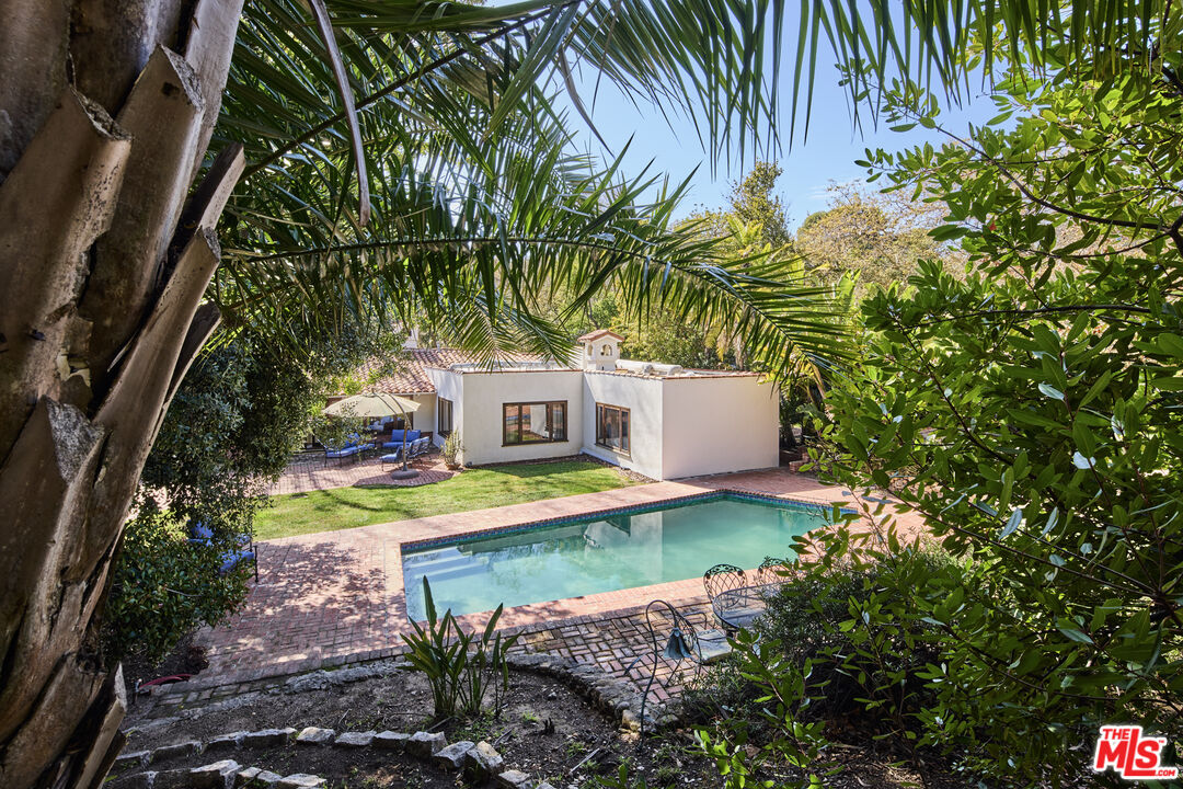 6138 Ramirez Canyon Road Malibu, CA 90265 - Photo 2 of 31 a view of a house with pool and a yard