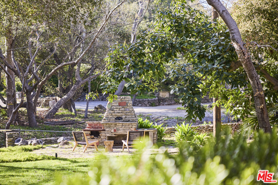 6138 Ramirez Canyon Road Malibu, CA 90265 - Photo 28 of 31 a view of swimming pool with outdoor seating and trees