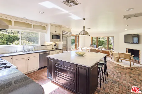 a kitchen with a stove a sink and a refrigerator