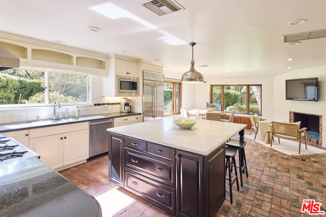 6138 Ramirez Canyon Road Malibu, CA 90265 - Photo 7 of 31 a kitchen with a stove a sink and a refrigerator