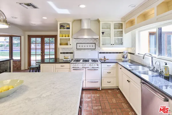 a kitchen with a stove a sink and a refrigerator