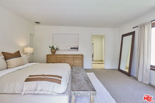 a bedroom with a large bed and a couch